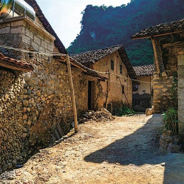 A stone-walled lane between traditional Tày houses in Khuổi Ky stone village, Cao Bằng