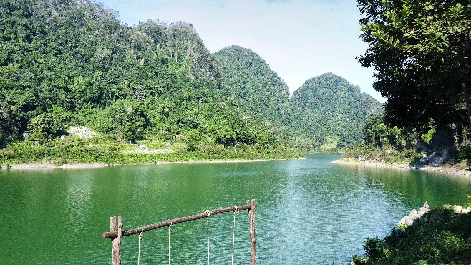 Emerald water of Thang Hen Lake between forested limestone hills, Cao Bằng
